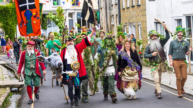 A colourful pageant, known as Hal an Tow, featuring people dressed as characters from the song 